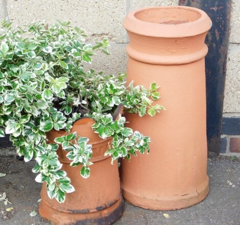 A terracotta chimney pot, of cylindrical form, 57cm high, together with a terracotta planter. (2)