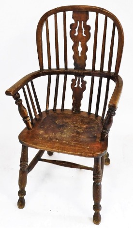 A 19thC oak and elm Windsor chair, with a carved splat, solid saddle seat, raised on turned legs united by a H frame stretcher, 56cm wide.