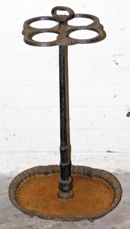 A Victorian cast iron umbrella stand, with four circular divisions, reeded tapering column, and a shaped galleried base, 66cm high.