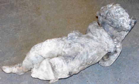 A lead garden putto, modelled holding a fish, possibly part of a larger fountain or water feature, 85cm high.