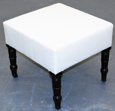 A 19thC oak stool, with calico upholstered padded seat, on turned legs with brass castors, 46cm wide.