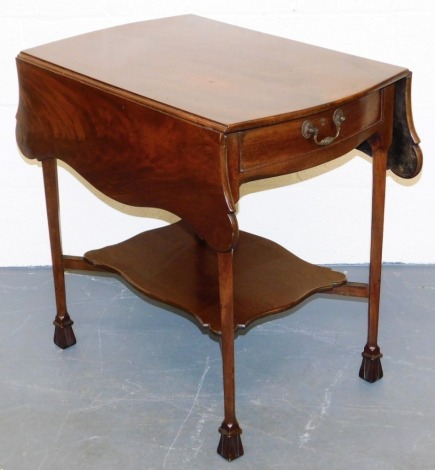 A George III mahogany Pembroke table, the butterfly shaped figured top above a frieze drawer, on square tapering legs with shaped under tier and block feet, possibly adapted, 71cm high, 72cm wide.