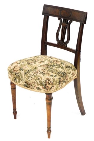 A late George III mahogany side chair, with bar back, a lyre shaped support and a padded seat, on turned tapering legs.