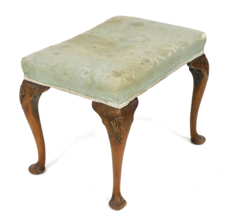 A George II style walnut stool, with a padded seat, on shell carved cabriole legs and pad feet.