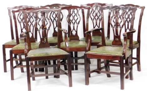 A set of eight Chippendale style mahogany dining chairs, each with a pierced Gothic shaped splat, a tooled green leather drop in seat, on channelled legs with H stretcher, comprising a pair of carvers and six single chairs.