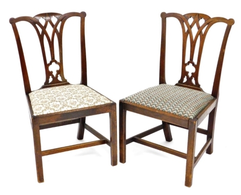 A pair of George III mahogany dining chairs, each with a vase shaped splat and a drop in seat on plain supports with H stretcher.