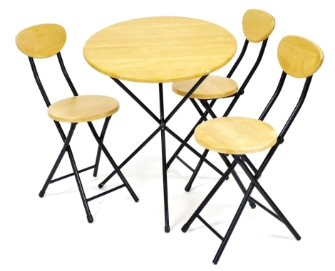 A Scandinavian ash folding table, on an ebonised metal base, the circular top 61cm high, and four folding chairs.