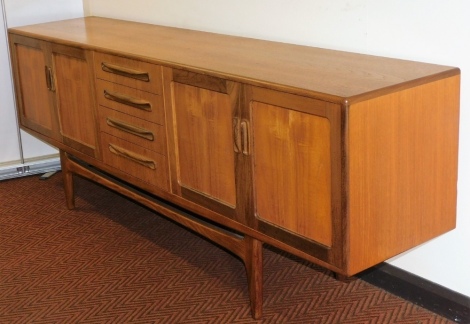 A G Plan teak sideboard, with four central doors flanked by two pairs of cupboard doors, raised on tapering turned legs, 79cm high, 213cm wide, 46cm deep.