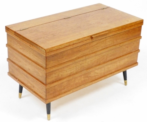 A mid century teak blanket box, possibly Danish, raised on turned legs, brass capped, 50cm high, 78cm wide, 41cm deep.