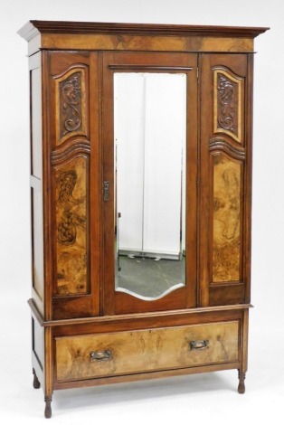 A Victorian walnut and burr walnut double wardrobe, the outswept pediment over a central bevel glass mirrored door, opening to reveal a hanging rail and hooks, over a single frieze drawer, raised on turned feet, 204cm high, 124cm wide, 53cm deep.