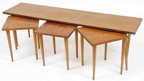 An Alberts Tibro Swedish quartetto of teak occasional tables, with one long rectangular table, raised on turned legs, 40cm high, 132cm wide, 32cm deep, and three smaller square tables, 37cm high, 32cm wide.