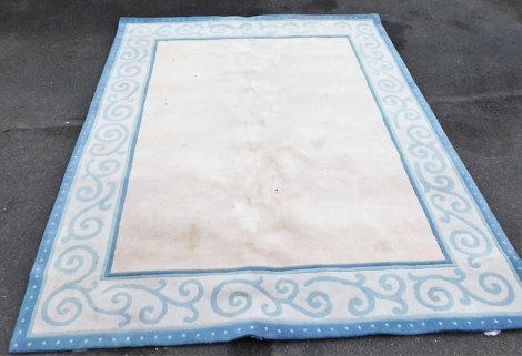 A blue and cream ground rug, 236cm x 300cm.