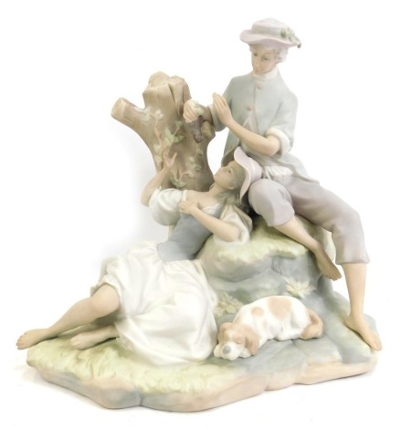 A Lladro matt porcelain figure group, modelled as a lady and gentleman eating grapes, 26cm high.