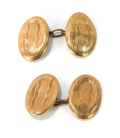 A pair of 9ct gold oval cufflinks, each with pin stripe design and chain link, 2.5g all in. (AF)