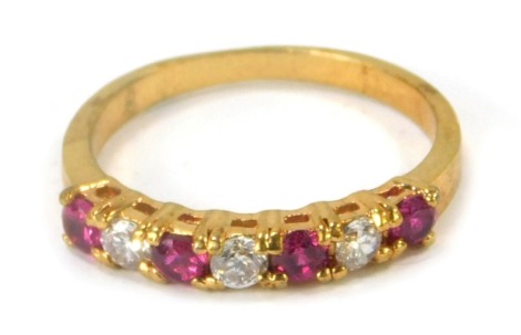 A dress ring, set with paste stones, on a gold plated band, ring size Q.