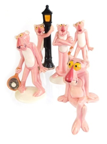 A group of four Japanese ceramic United Artists Pink Panther figures, two playing tennis, one standing beside a lamp post, the other seated, various sizes. (4)