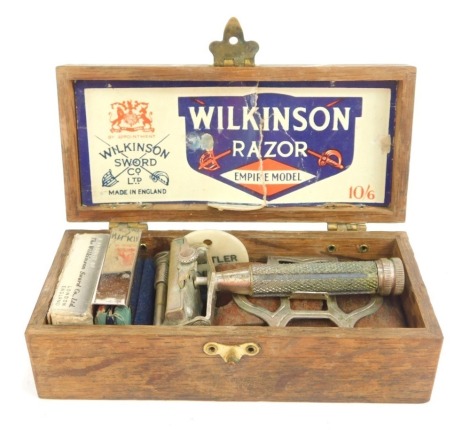 A Wilkinson Empire Model razor, with some attachments, card, etc, in hardwood box, 12.5cm wide.