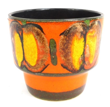 An unusual 1970's glazed tumbler vase, decorated in glazed yellow and brown, on a vivid orange ground, unmarked, 10cm high. Keywords for interested party searches: Poole, Delphis, West German, Fat Lava