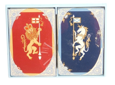 A set of non standard 1957 Thomas De La Rue & Co playing cards, unopened, showing the lion dexter and unicorn sinister, in blue plastic case, purportedly for use by the Royal Family.