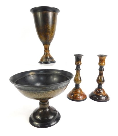 Four items of patinated brassware, comprising a pair of mottled design candlesticks, 18cm high, a fluted goblet, 31cm high, and a pedestal bowl, 20cm high. (4)