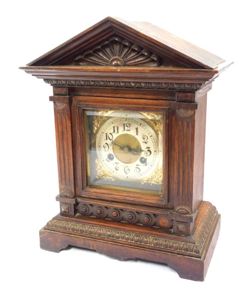 A late 19thC German oak cased mantel clock, the brass square dial with ...