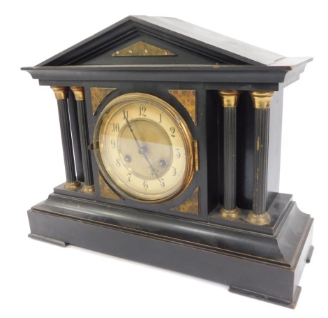 A late 19thC ebonised mantel clock, circular brass dial with chapter ring bearing Arabic numerals, Junghans eight day movement with coil strike, the case of architectural with four brass capped fluted columns, with pendulum and key, 35cm high, 43cm wide, 