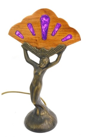 An Art Deco style table lamp, depicting semi clad female, with fanned top, with inlaid wooden panel, 34cm high.