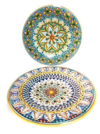 A pair of Italian pottery chargers, each elaborately decorated in bold coloured glaze, with flower design, one marked Amalfi, 40cm diameter.