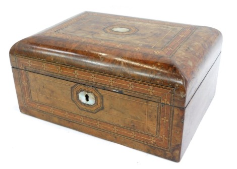 A Victorian walnut sewing box, with a domed top, inlaid with mother of pearl and boxwood strung, with a purple cushioned interior, 13cm high, 27cm wide, 20cm deep.