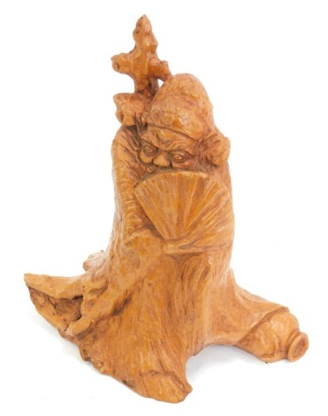 Chinese Art. A carved wooden figure of Feng Bo, with fan, morphing into a tree stump, 29cm high.