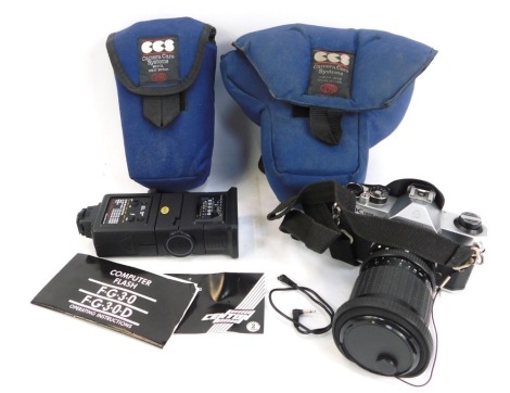 An Asahi Pentax K1000 camera, with Sigma 1-3.5 - 4.5 28-84mm lens, and additional flash, in blue carry case. (2)