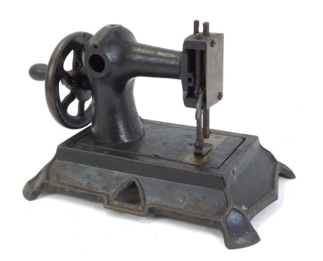 A 19thC child's cast iron sewing machine, possibly by Muller of Germany, unmarked, 16cm high, 23cm wide.