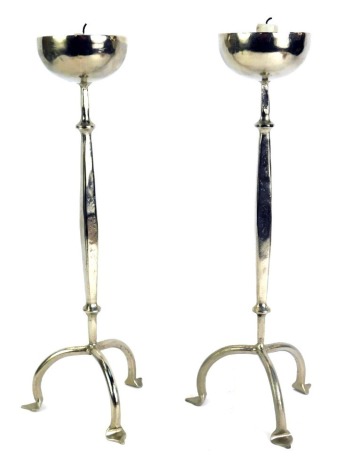 A pair of Arts & Crafts style plated tapered candlesticks, on tripod base, 40cm high.