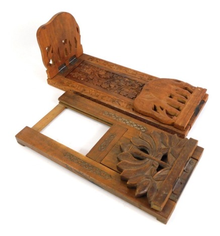 Two carved Anglo-Indian hardwood book slides, comprising one with elephant ends, 32cm wide, and another with lotus flower ends, 31cm long, one end missing. (2, AF)