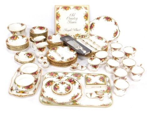 A Royal Albert Old Country Roses pattern part tea and dinner service, comprising placemats, six dinner plates, cased cake slice, plastic tray, rectangular serving tray, ten teacups, twelve saucers, two milk jugs, three tier cake plate, salt and pepper, sh