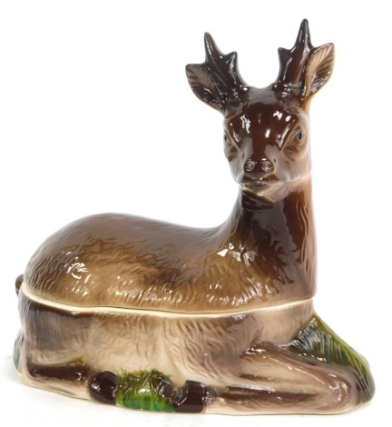 A pottery venison tureen and cover, modelled as a recumbent deer, unmarked, 22cm high, 24cm wide.