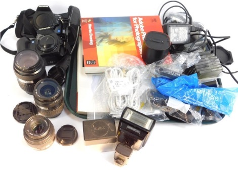 Cameras and accessories, comprising Olympus E500 camera, Olympus E400 camera, Zuiko digital 50mm lens, Zuiko digital 14-45mm lens, Zuiko digital 40-150mm lens, Olympus flash, charger packs, Polaroid diffusers, books to include Photoshop essential guides,