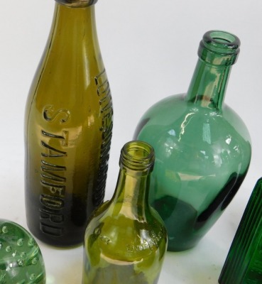 A collection of 19thC and later green glass bottles, comprising Low Sun and Cobbald Limited of Stamford, George Shaw and Co Limited Leigh Brewery, Green Poison bottle, another stamped Des Bauphins, JH Cuff Limited of Manchester, three unmarked green glass - 3