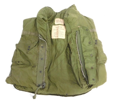 An Armour Body bullet proof gillet, in green, bearing labels, size medium.