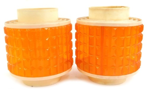 A pair of 1970's lamp shades, each with a cream plastic rim, with pointed orange shade, 25cm high.