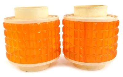 A pair of 1970's lamp shades, each with a cream plastic rim, with pointed orange shade, 25cm high.