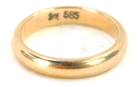 A wedding band, of plain design, yellow metal stamped 585, ring size I½, 3.6g.