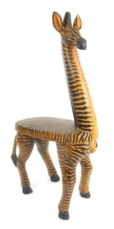 A carved and painted hardwood zebra seat, 61cm high.