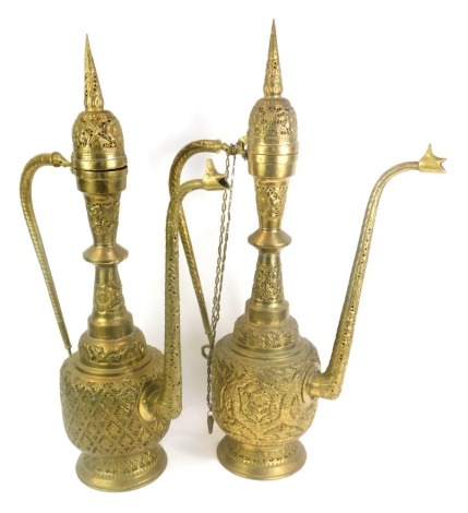 Two Eastern brass coffee pots, 70cm high.