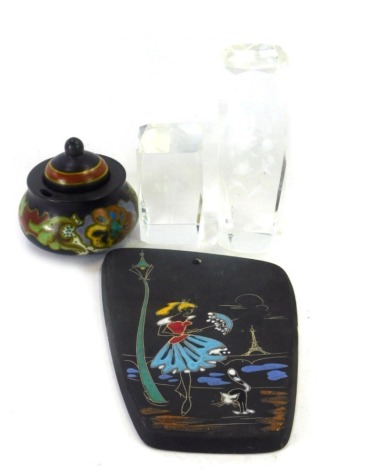 A group of mid century ceramics and glassware, comprising a 1950s Keto Keramic painted plaque, with lamp post, female and cat, 20cm high, a Gouda pottery inkwell, 9cm high, and two glass paperweights, one decorated with flowers and humming birds, the othe