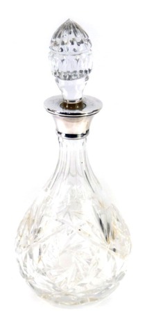 An Elizabeth II silver and cut glass decanter, the shaped stopper with star cut finial, with a silver mount, Birmingham 1968, 28cm high.