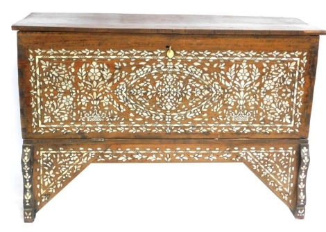 A 19thC Syrian hardwood marriage chest, with mother of pearl and bone inlay, the hinged lid over a panelled front, raised on shaped legs, united by a triangular and straight frieze, 105cm high, 158cm wide, 58.5cm.