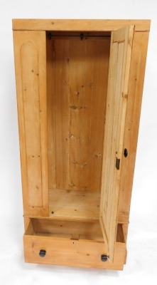 A late 19thC pine single wardrobe, with a panelled door opening to reveal a hanging rail and hooks, over a frieze drawer, raised on a plinth base, 189cm high, 86cm wide, 44cm deep. - 2