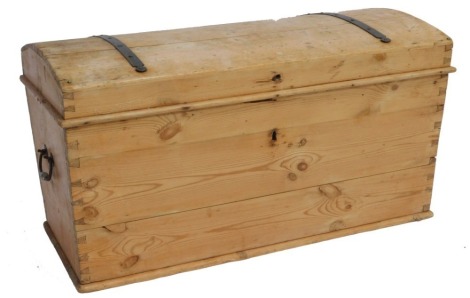 A Victorian domed pine and iron bound trunk, with cast iron carrying handles, 54cm high, 103cm wide, 53cm deep.