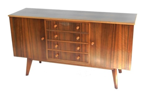 A Morris of Glasgow Cumbrae Furniture rosewood and beech sideboard, having four central drawers, flanked by two cupboard doors, raised on tapering legs, 85cm high, 156cm wide, 48cm deep.